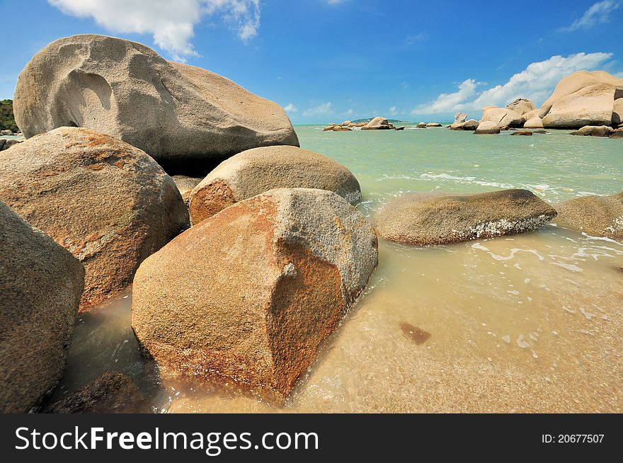 Sea beach coast full of rock under summer lighting, shown as featured sea coast physiognomy and different color in rock, sky and sea water. Sea beach coast full of rock under summer lighting, shown as featured sea coast physiognomy and different color in rock, sky and sea water.