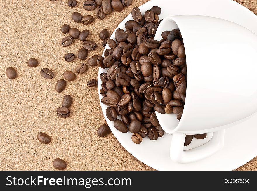 Sprinkled cup of coffee beans