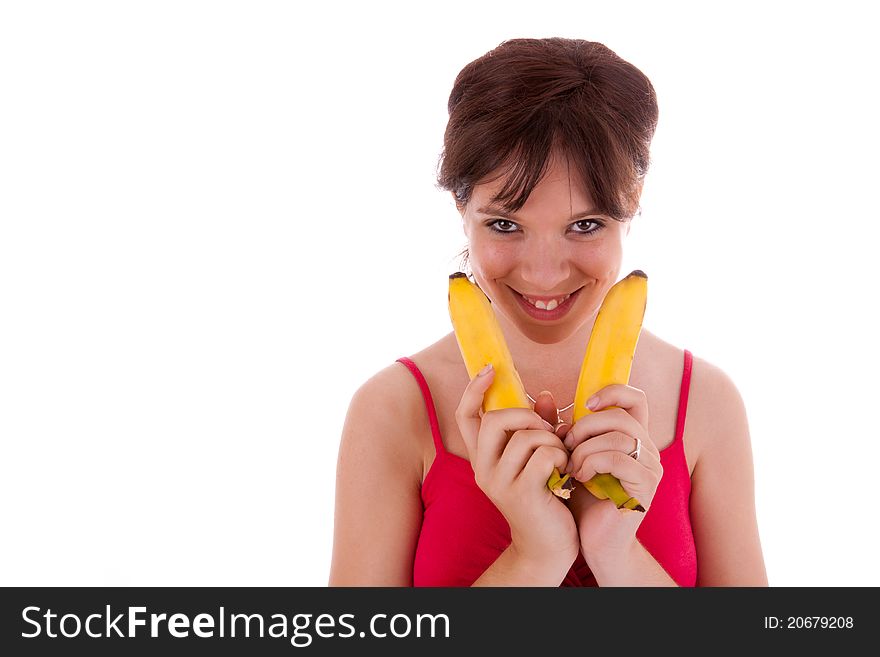 The pretty young woman has two bananas in her hand. The pretty young woman has two bananas in her hand