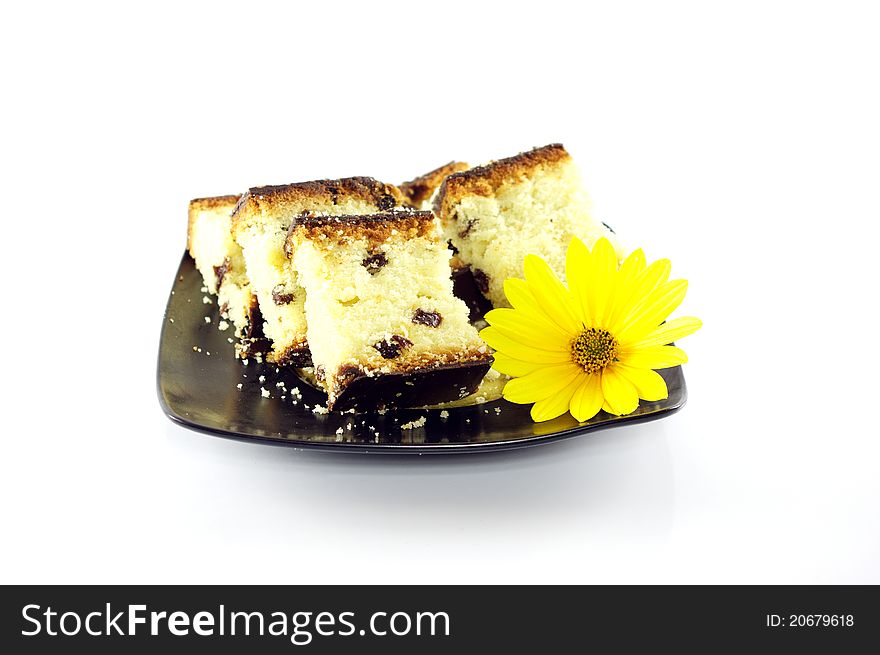 Sliced cake decorated with yellow flower on white background. Sliced cake decorated with yellow flower on white background