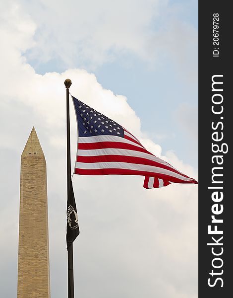 Washington D.C. monument with the American flag in the foreground. Washington D.C. monument with the American flag in the foreground.