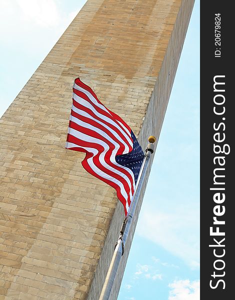 Washington D.C. monument with the American flag in the foreground. Washington D.C. monument with the American flag in the foreground.