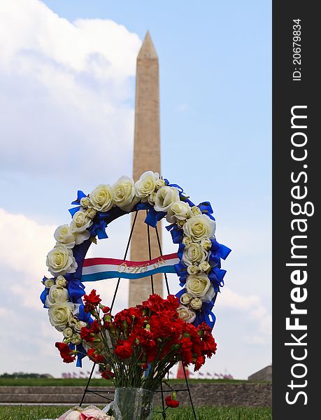 Washington Memorial with a wreath of flowers nearby mourning the loss of a soldier. Washington Memorial with a wreath of flowers nearby mourning the loss of a soldier.