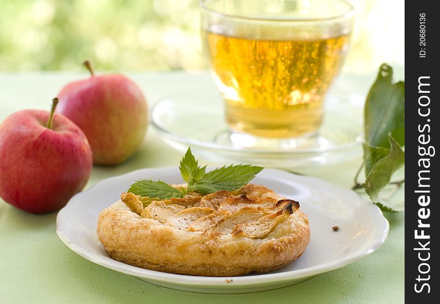 Apple cakes with cup of tea . Selective focus