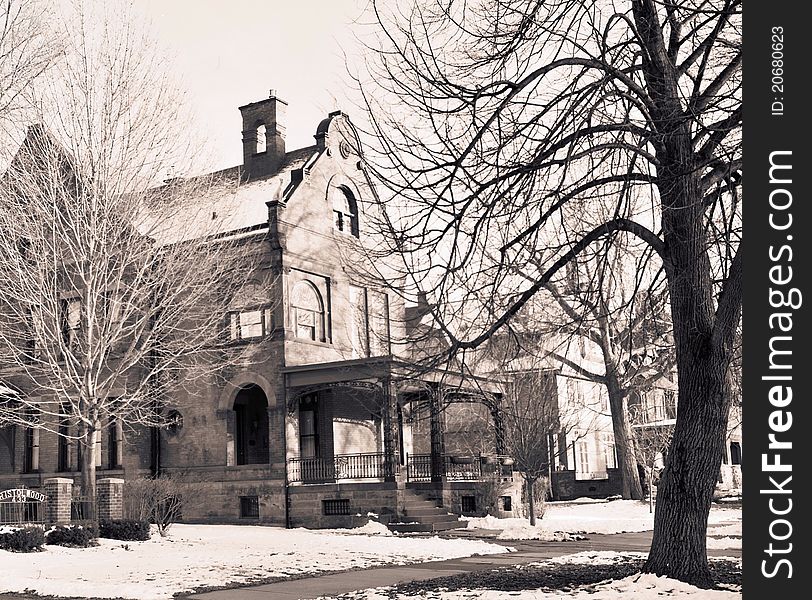 Eerie old mansion, 19th Century, with sparse winter tree branches around it, is both beautiful and mysterious. Eerie old mansion, 19th Century, with sparse winter tree branches around it, is both beautiful and mysterious.