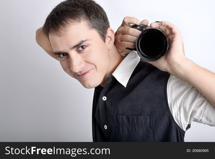 Attractive photographer (paparazzi) with digital camera. Concepts: shoulder like tripod, the paparazzi shooting unusual shot in unusual position. Attractive photographer (paparazzi) with digital camera. Concepts: shoulder like tripod, the paparazzi shooting unusual shot in unusual position.