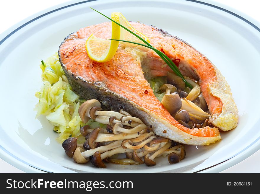 Salmon, grilled with mushrooms, cabbage and lemon. Salmon, grilled with mushrooms, cabbage and lemon.