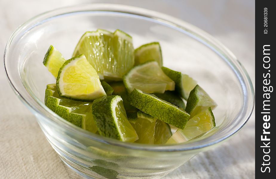 Slices of green lime in a glass bowl. Slices of green lime in a glass bowl