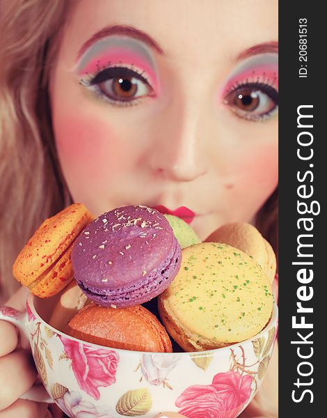 A young woman loves her sweet macaron. A young woman loves her sweet macaron.