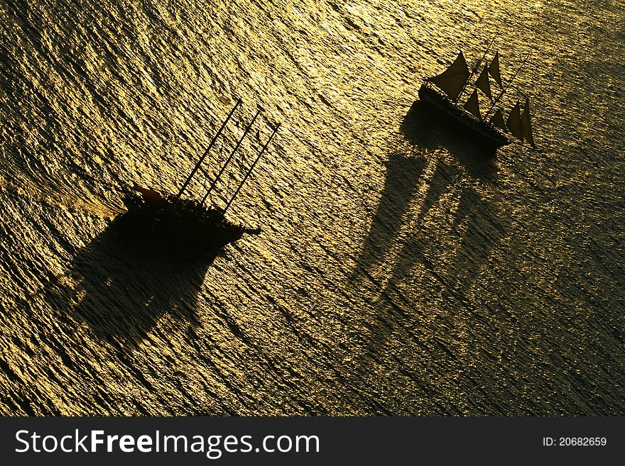 Two sail boats carrying tourists to see the stunning sunset in Santorini island, Greece. Two sail boats carrying tourists to see the stunning sunset in Santorini island, Greece