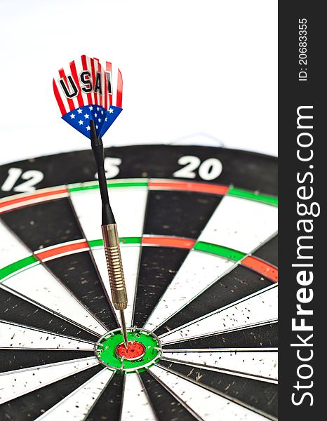Dart in center of dartboard with isolated white background. Dart in center of dartboard with isolated white background