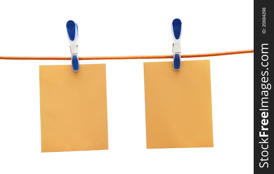 Two yellow notes hang with cloth pegs