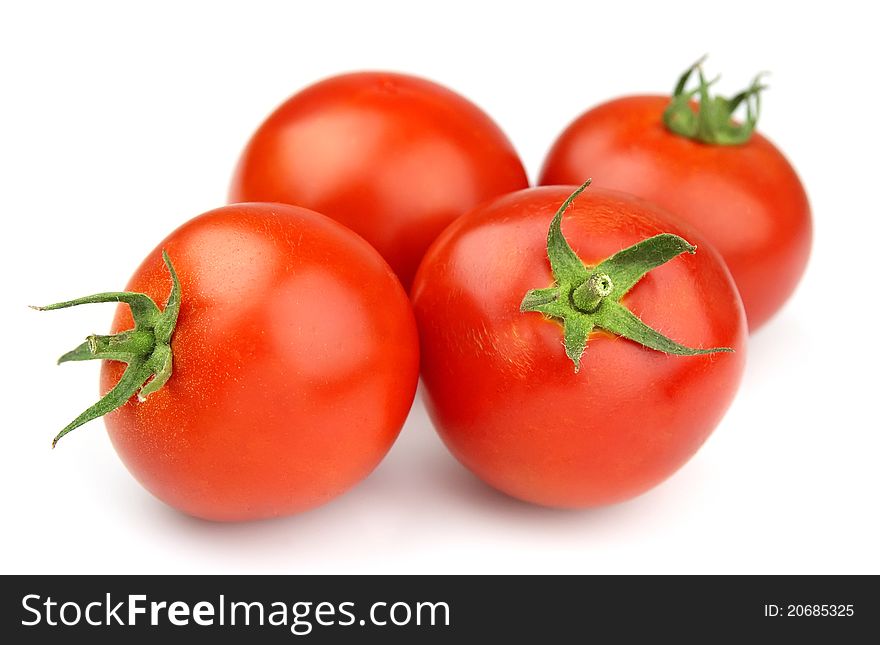 Sweet tomatoes over white close up