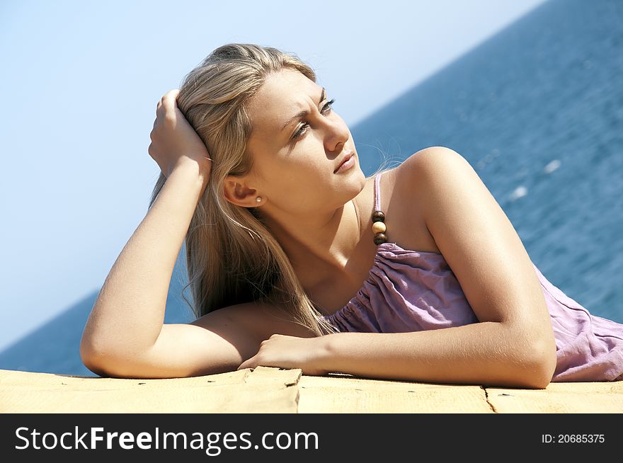 Portrait of a beautiful young woman posing near sea