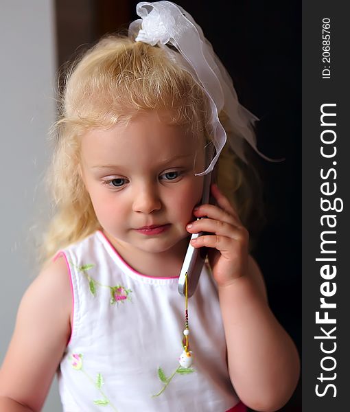 Little Caucasian Girl Listening To Mobile Phone