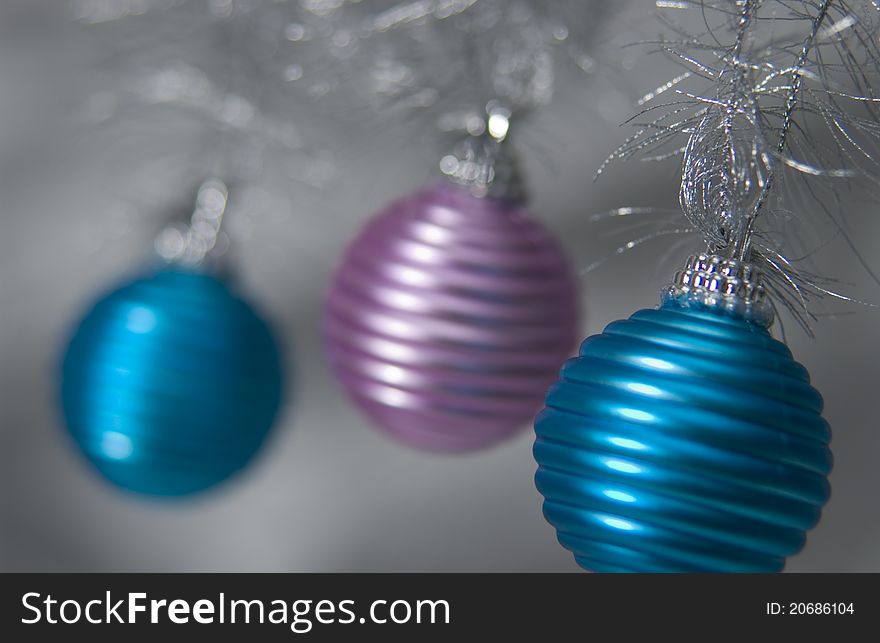 Three hanging metallic christmas ornaments