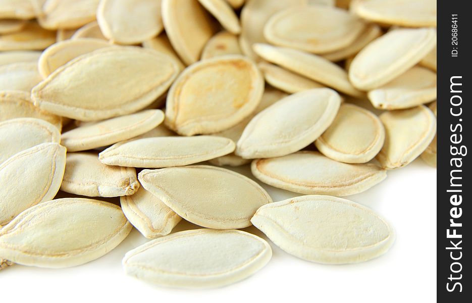Dried pumpkin seeds isolated on white