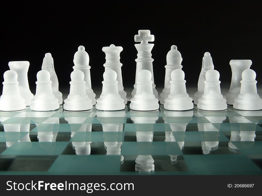 Glass chess on the chess board. Glass chess on the chess board