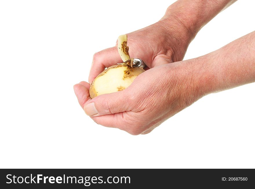Male hands peeling a potato isolated against white