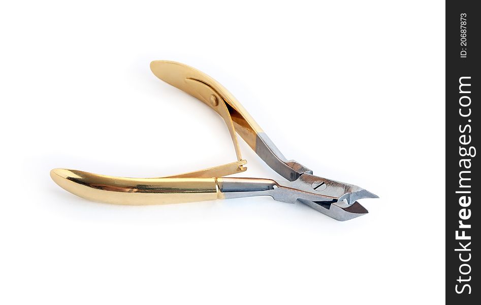 Golden manicure nail clipper isolated on white background with clipping path. Golden manicure nail clipper isolated on white background with clipping path