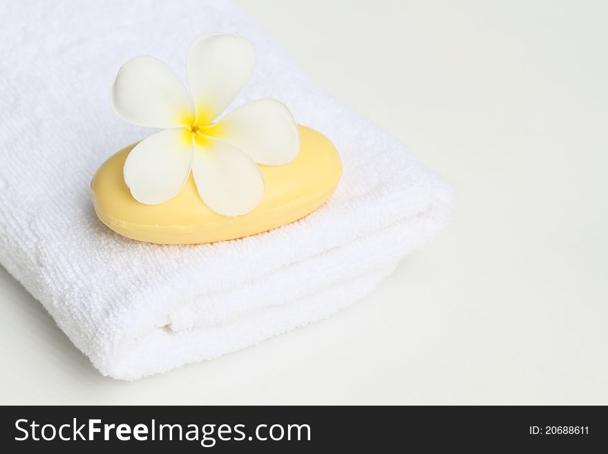 White towel,plumeria flower and soap. White towel,plumeria flower and soap