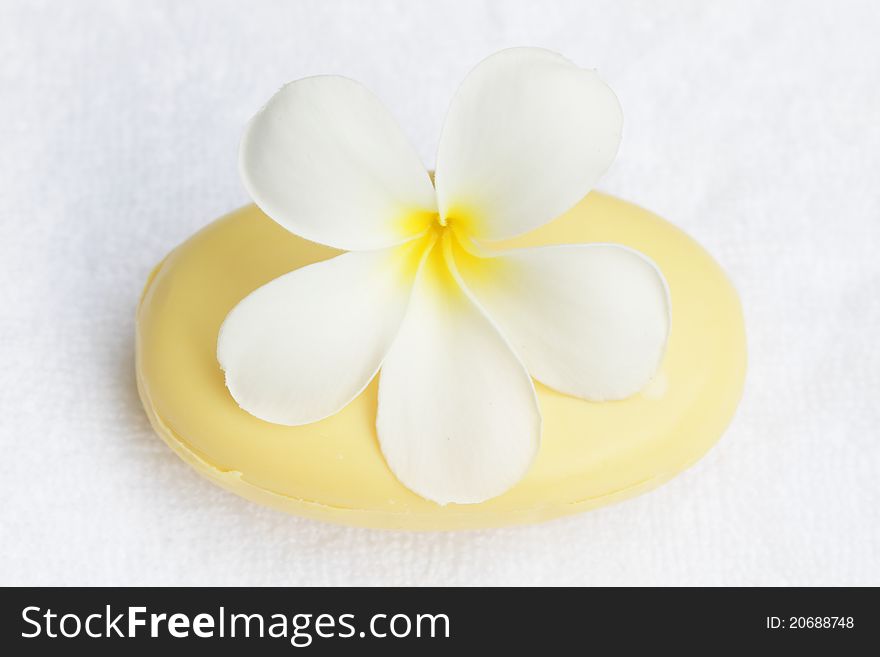 White towel,plumeria flower and soap. White towel,plumeria flower and soap