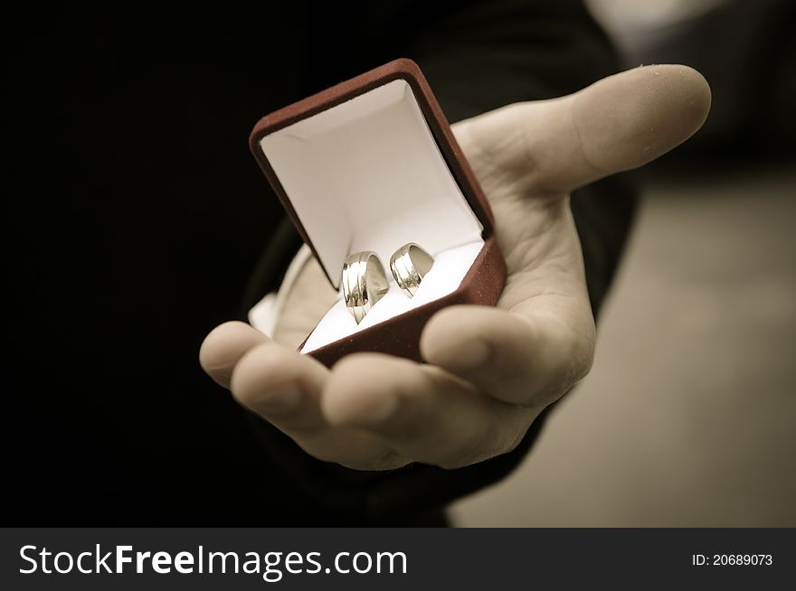 Wedding rings in groom's hands. Wedding rings in groom's hands