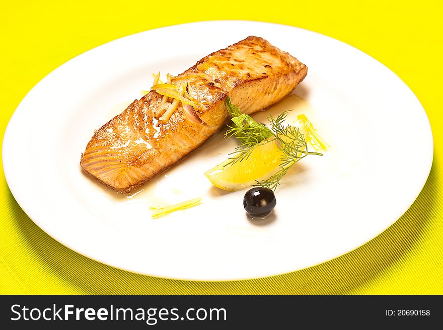 Grilled salmon on white plate