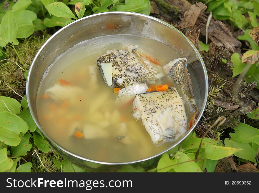 Fish soup on wood ground outdoor. Fish soup on wood ground outdoor