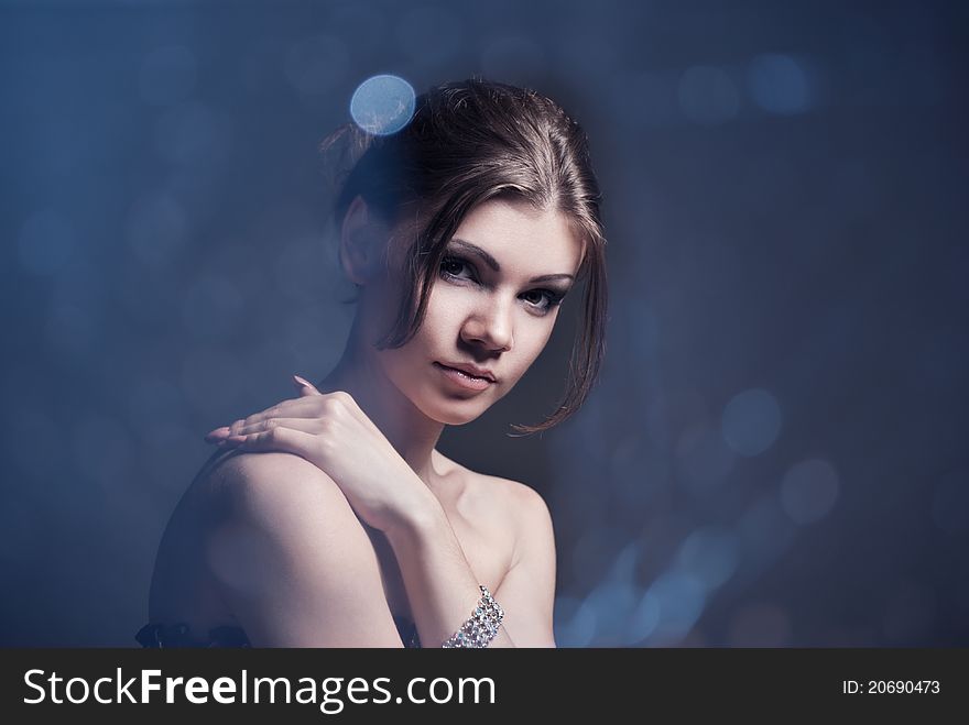 Fashion portrait of the young brunette woman with perfect makeup. Beauty portrait studio shot. Fashion portrait of the young brunette woman with perfect makeup. Beauty portrait studio shot