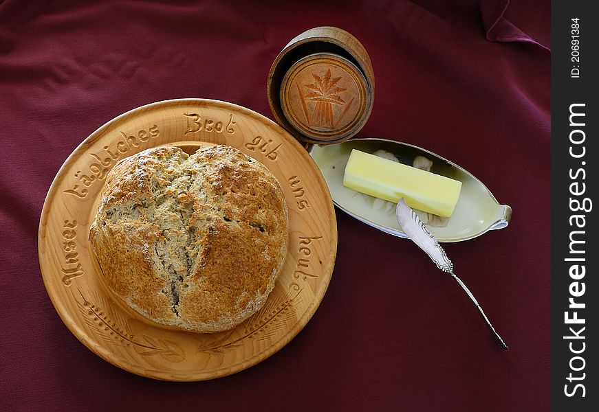 Whole Wheat Bread with vintage wooden butter mold and butter on vintage butter dish