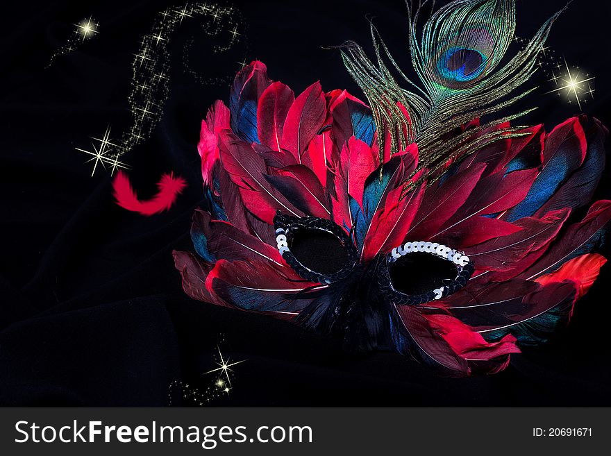 Beautiful carnival mask on black fabric