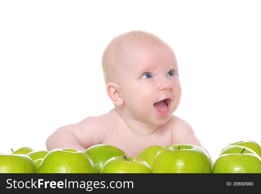 Small child sitting in the green apples isolated on white