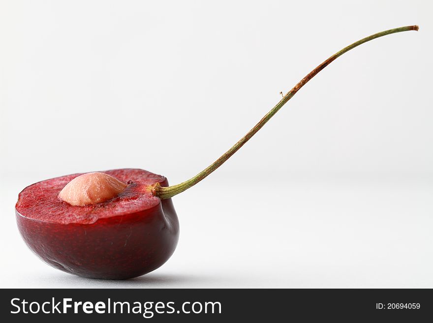 Half of a cherry with seed shown in the centre. Half of a cherry with seed shown in the centre