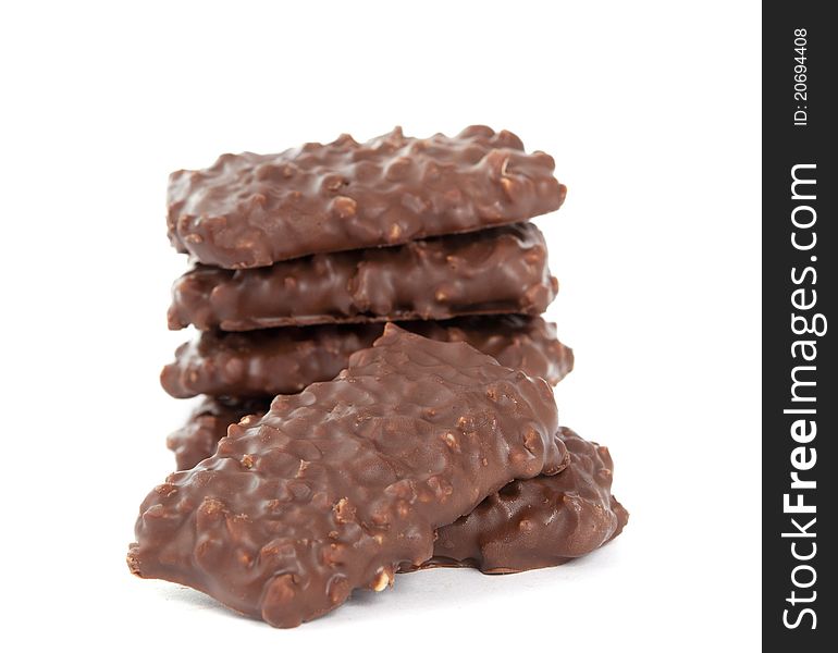 Biscuits with chocolate and nuts on white background