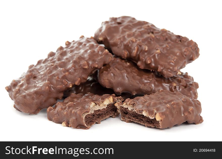 Biscuits with chocolate and nuts on white background