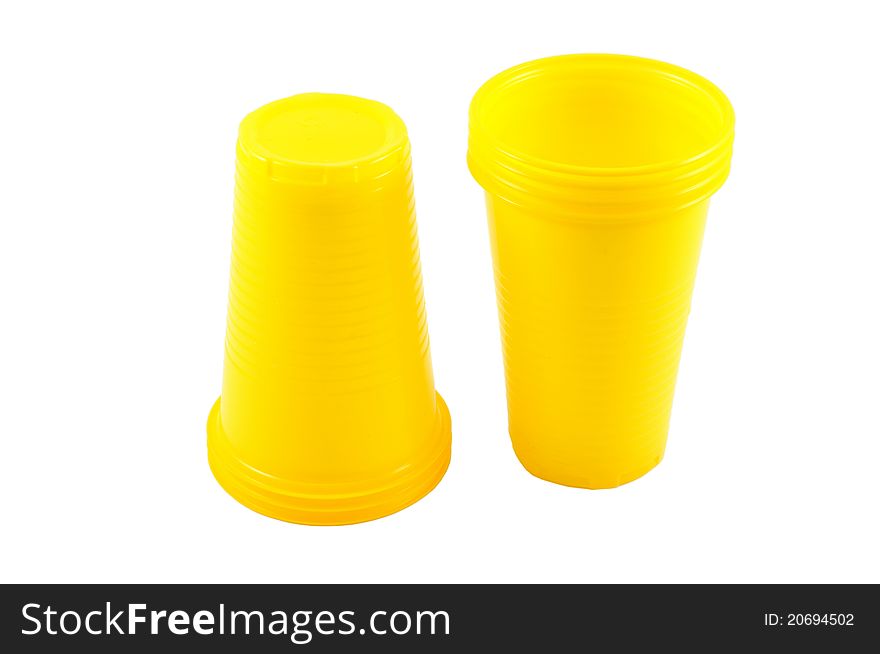 Yellow plastic cups isolated on a white background