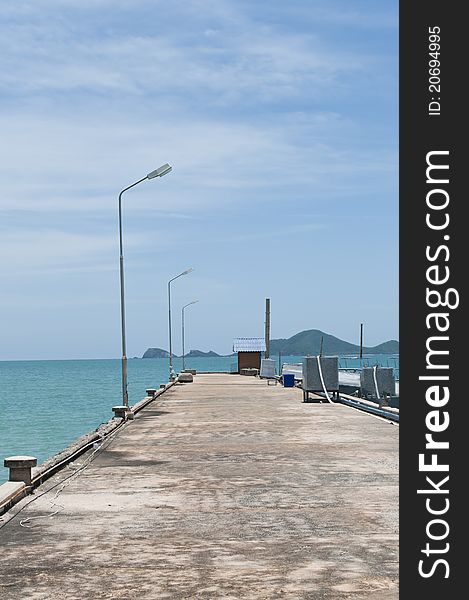 A concrete dock with bright sky.