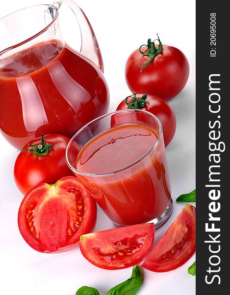Jug, glass of tomato juice and fruits