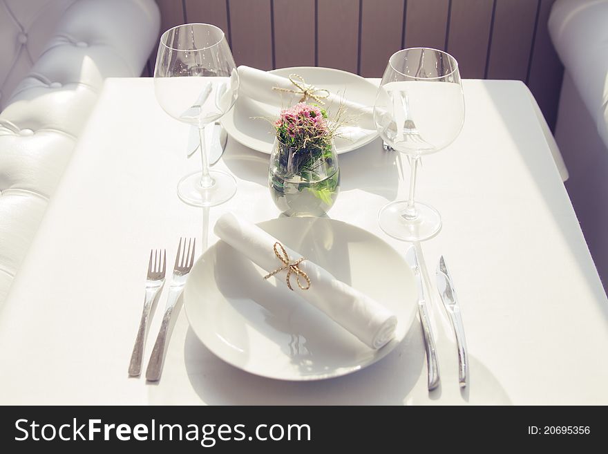 Served table with glasses for two persons in cafe