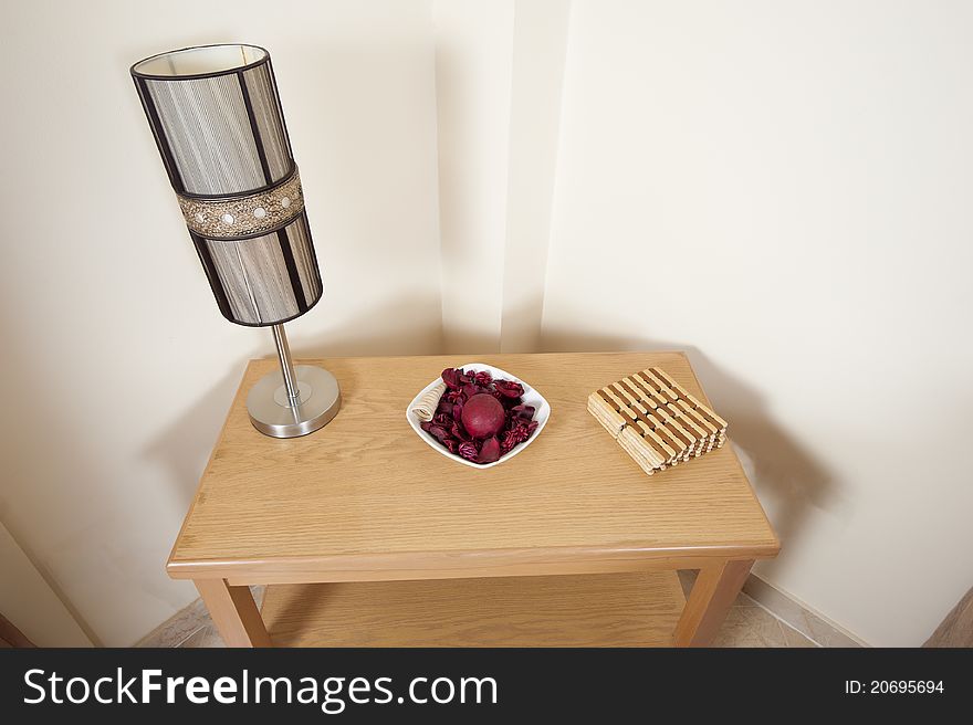 Small interior wooden table with lamp and decoration on. Small interior wooden table with lamp and decoration on