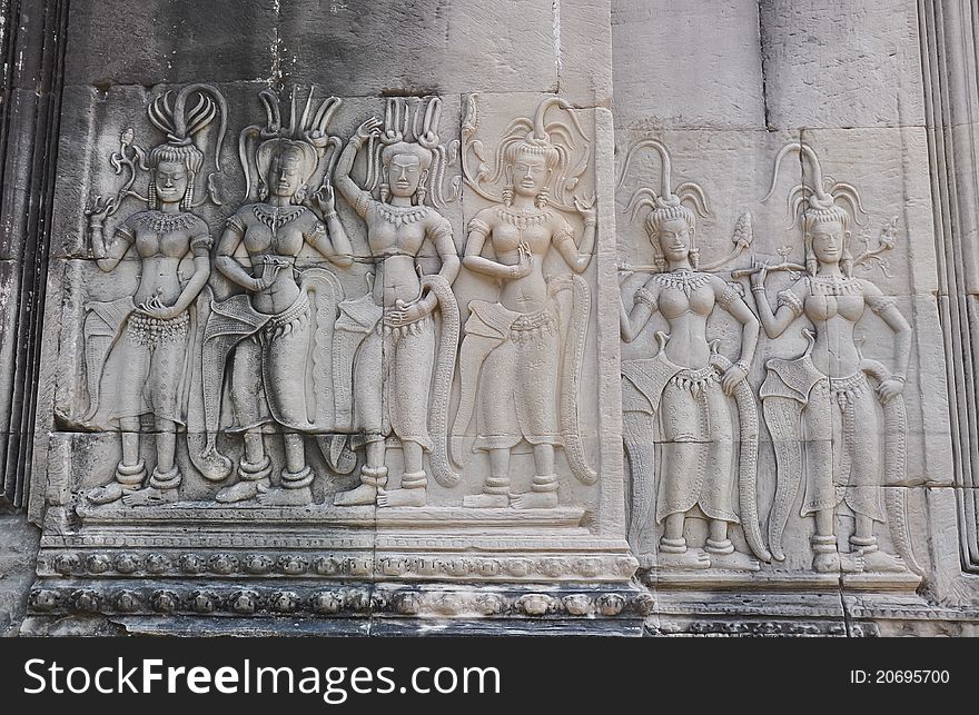 Apsaras engraved in the wall performing eternal dance.