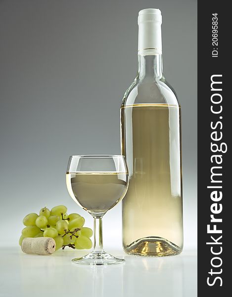 White wine, a bottle, a glass and some grapes. White wine, a bottle, a glass and some grapes