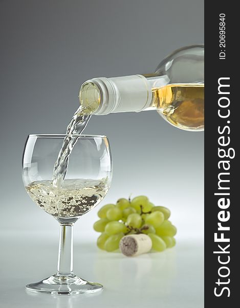 Pouring a glass of white wine. Pouring a glass of white wine