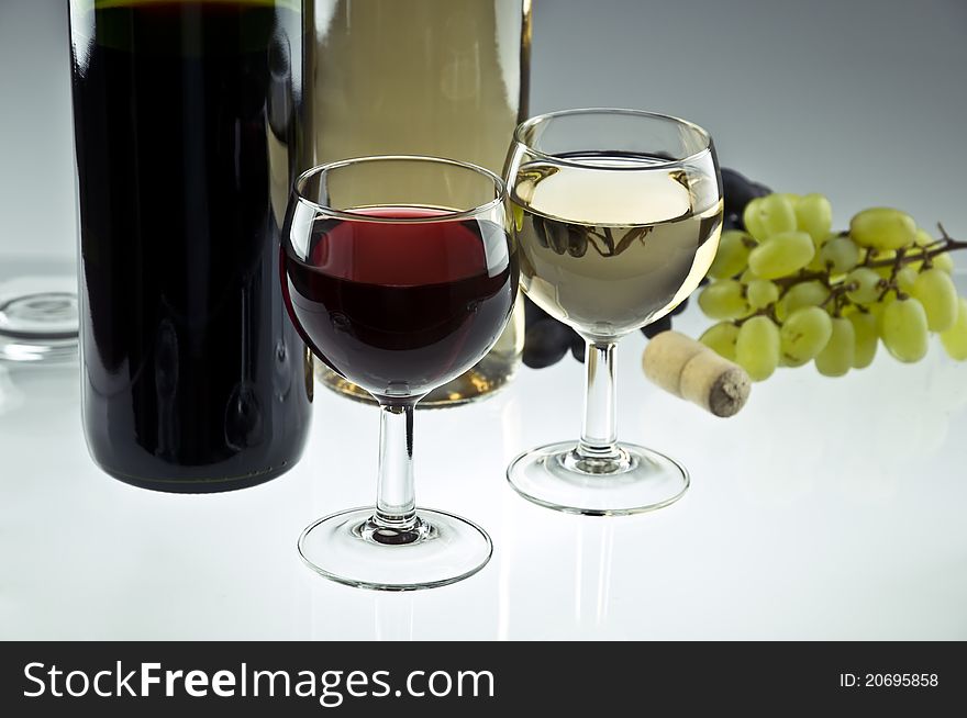 Red and white wine bottles and glasses