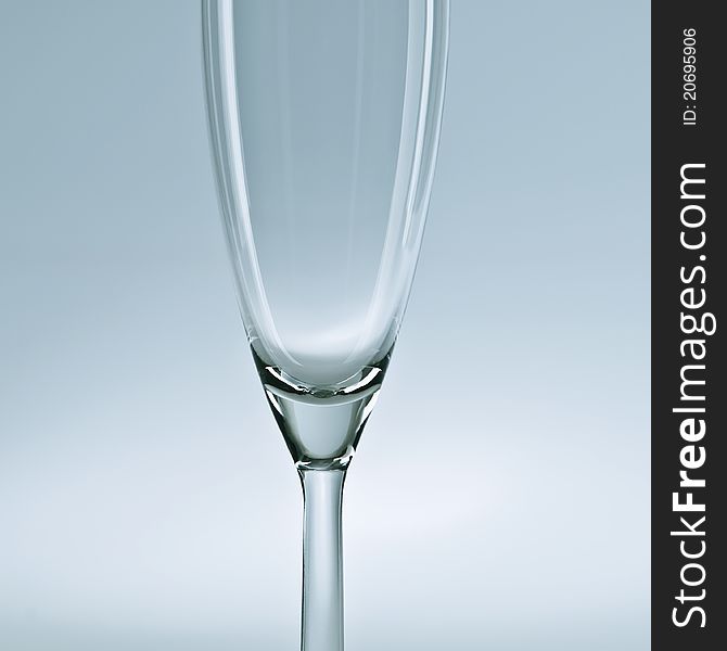 Empty champagne glass on a blueish background