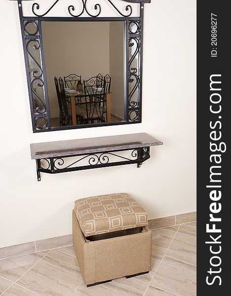 Interior design mirror and shelf on a wall with stool. Interior design mirror and shelf on a wall with stool