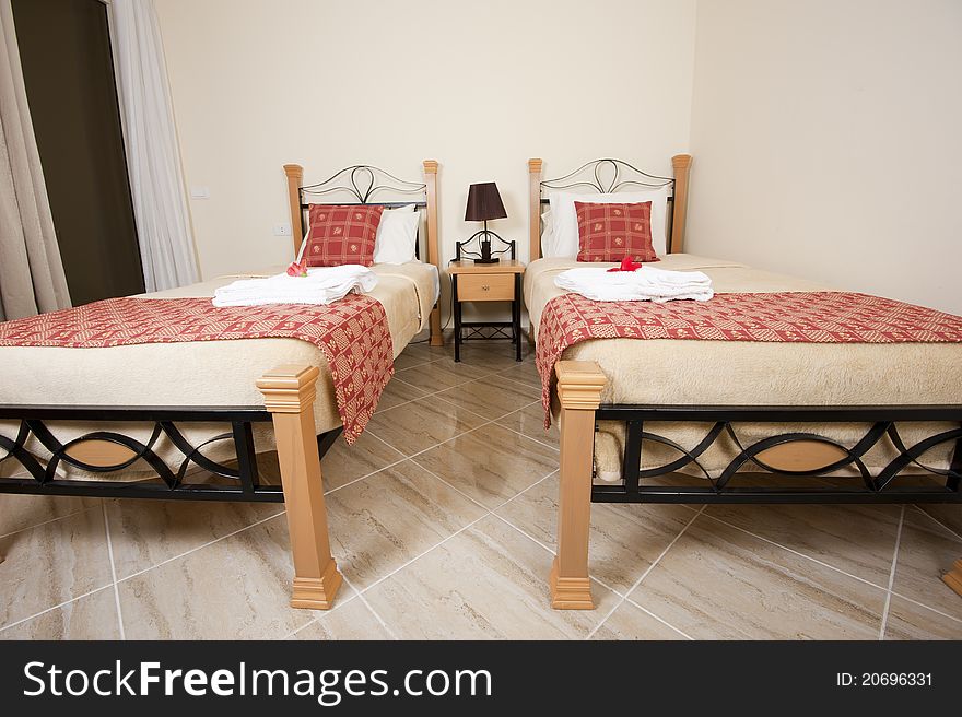 Two single beds in a twin bedroom showing interior decor and design. Two single beds in a twin bedroom showing interior decor and design