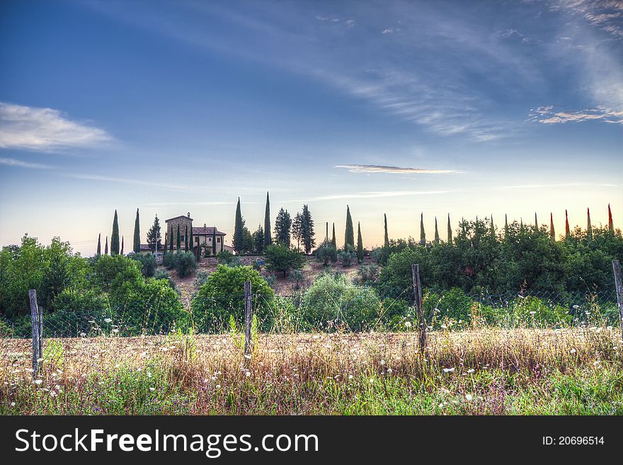 Sunrise in Tuscant over a Farm surrounded by Cypresses. Sunrise in Tuscant over a Farm surrounded by Cypresses