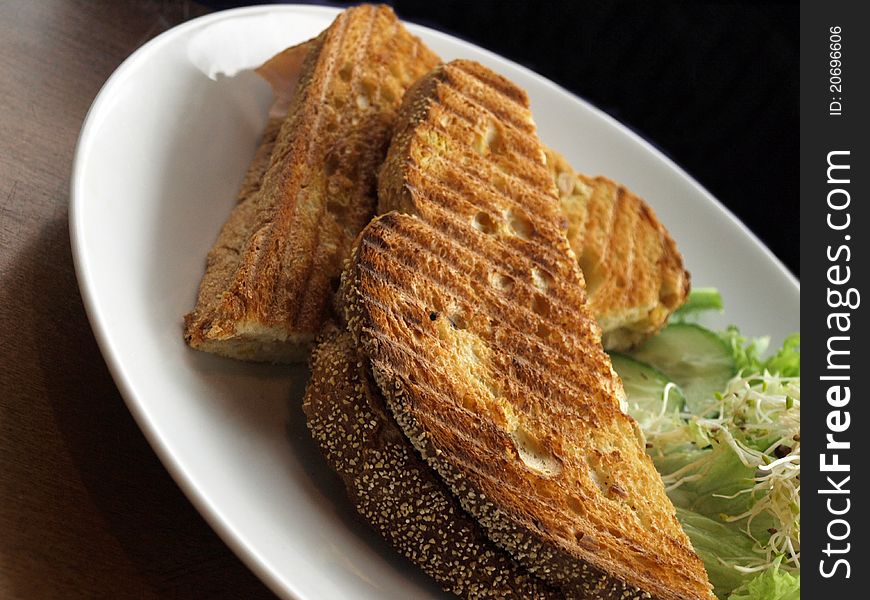 Toasted bread on a table served with salad